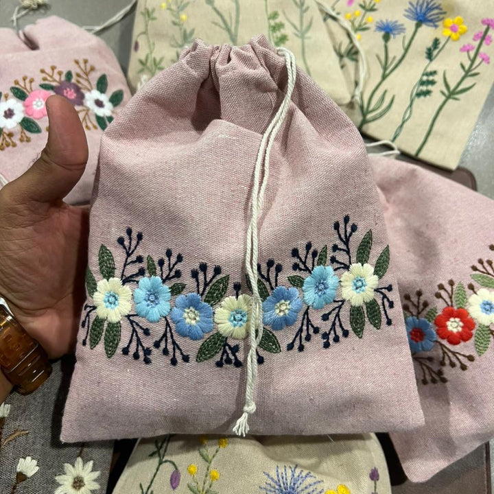 Embroidered drawstring bag with floral designs
